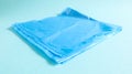 One torn plastic garbage bag in blue on a blue background. A bag that is designed to accommodate garbage in it and is used at home Royalty Free Stock Photo