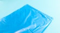 One torn plastic garbage bag in blue on a blue background. A bag that is designed to accommodate garbage in it and is used at home Royalty Free Stock Photo