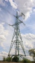 One tower, high voltage power lines. High voltage cables. High voltage electrical tower on the field. against the blue sky.