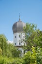 One tower of water castle Schwindegg, inmidst green trees, upper bavaria