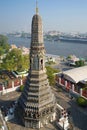 One of the towers of the temple Wat Arun in the background of the urban landscape. Bangkok