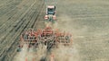 One tractor accomplishes seasonal works before making crops. Aerial 4K.