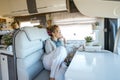 One traveler woman having relax inside modern camper van renting rv vehicle for alternative tiny house or travel vacation. Vanlife Royalty Free Stock Photo