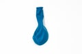 One turquoise inflatable uninflated colored balloon for the holiday lies on a white background Royalty Free Stock Photo