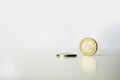 One and two euro coins with reflection white background