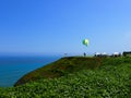 One unidentified person with a no engine paraglider is ready to jump and fly on the coastline of Miraflores district of Lima.