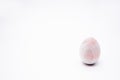 One unpainted hand-made wooden egg on a white background. Copy space