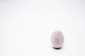 One unpainted hand-made wooden egg on a white background. Copy space