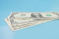 One US dollar bills on a blue background. Royalty Free Stock Photo