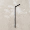One use plastic disposable drinking straw on concrete background Royalty Free Stock Photo