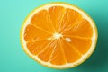 One vibrant orange slice on a turquoise green background, a zesty citrus texture