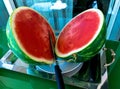 One watermelon cuted in halves on matal tray on glass table