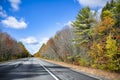 One-way highway landscape with scenic yellowed autumn maple trees on the sides in New Hampshire New England Royalty Free Stock Photo