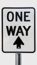 ONE WAY sign with arrow pointing straight ahead