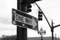 One way sign hanging on a pole on a crossroad traffic light