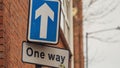 One way street sign hanging from a lamp post Royalty Free Stock Photo