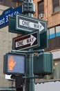 One way street sign pole in New York with red traffic light Royalty Free Stock Photo