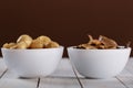 mushrooms in oil in ceramic bowl on white wooden background