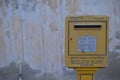 One weathered yellow mailbox in the street of a popular district of Doha