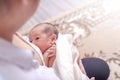 One week little baby girl feeding milk in mother arms. Mother embrace her daughter