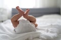 One week newborn adorable baby lying at baycot and funny yawning.Portrait of sleepy caucasian infant tired child on bed