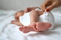 One week newborn adorable baby lying at baycot and funny yawning.Portrait of sleepy caucasian infant tired child on bed