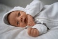 One week newborn adorable baby lying at baycot and funny yawning.Portrait of sleepy caucasian infant tired child on bed