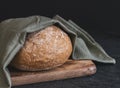 One wheat round bread with fiber on a black background. Royalty Free Stock Photo