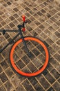 One wheel of red bycicle on floor Royalty Free Stock Photo