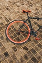 One wheel of red bycicle on floor Royalty Free Stock Photo