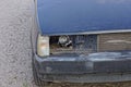 One white broken glass front bumper on the blue metal of a car near the black bumper Royalty Free Stock Photo