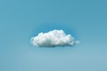 One white cloud floating in the sky against a solid blue background in a simple minimalistic style reminiscent of stop motion Royalty Free Stock Photo