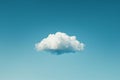 One white cloud floating in the sky against a solid blue background in a simple minimalistic style reminiscent of stop motion Royalty Free Stock Photo