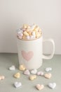 One white cup full of candy hearts Royalty Free Stock Photo