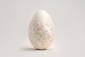 One white easter egg with beautiful gold floral pattern standing on light background. Generative AI Royalty Free Stock Photo