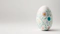One white easter egg with beautiful floral pattern standing on light background. Generative AI Royalty Free Stock Photo