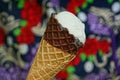 white ice cream in a brown waffle cup on a colored background Royalty Free Stock Photo