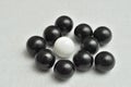 One white and a lot of black balls Royalty Free Stock Photo