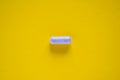 One white medical pill on yellow background Royalty Free Stock Photo