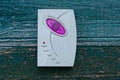 One white old plastic electronic doorbell with a purple lamp