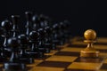 One white pawn against an army of black pieces on a chessboard Royalty Free Stock Photo