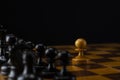 One white pawn against an army of black pieces on a chessboard Royalty Free Stock Photo