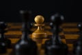 One white pawn against an army of black pieces on a chessboard Royalty Free Stock Photo