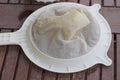 One white round plastic sieve