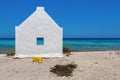 One white slave house on beach near blue sea