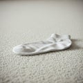 One white sock lies on the carpet. Royalty Free Stock Photo