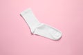 One white sock on pink background, top view Royalty Free Stock Photo