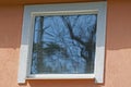 One white square large window on the brown concrete wall