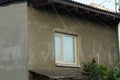 One white square large window on the gray concrete wall