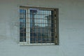 One white square window behind an iron bars Royalty Free Stock Photo